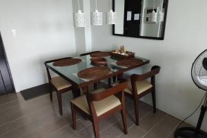 a dining room table with chairs and a mirror at QUIET HOME with private beach in Boracay
