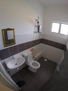 a bathroom with a toilet and a sink at Muslim Boutique Apartment with Balcony in Tanah Rata