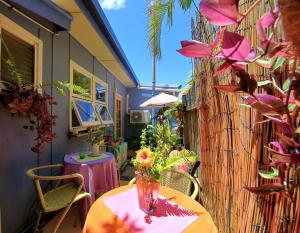 a table topped with flowers next to a building at Bargara Gardens Boutique Villas in Bargara