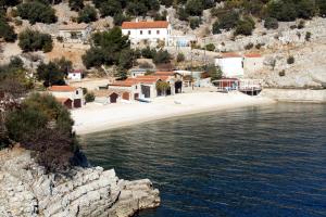 a group of buildings on a hill next to a body of water at Apartments with WiFi Beli, Cres - 8094 in Beli
