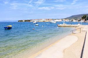 a beach with boats in a body of water at Apartments with a parking space Cres - 7985 in Cres