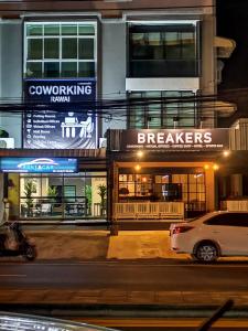 a car parked in front of a building at night at Breakers Hotel Rawai in Phuket