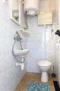 a bathroom with a toilet and a sink at Apartments by the sea Kabli, Peljesac - 10225 in Brijesta