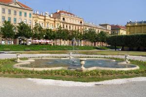 a fountain in a park in front of a building at Apartments with a swimming pool Zagreb - 11408 in Zagreb