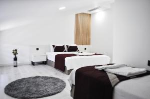 a hotel room with two beds and a rug at MAT BOUTIQUE HOTEL in Çeşme