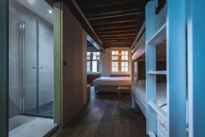 a bedroom with a bed and a glass shower at B&B BedStarLine in Antwerp