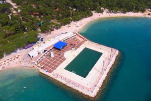 an aerial view of a beach with a swimming pool at Apartments by the sea Biograd na Moru, Biograd - 12747 in Biograd na Moru