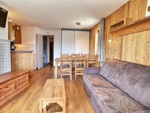 a living room with a couch and a table at Appartement La Tania, 2 pièces, 6 personnes - FR-1-182A-4 in Courchevel