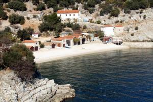 a group of buildings on a hill next to a body of water at Secluded house with a parking space Beli, Cres - 13893 in Beli