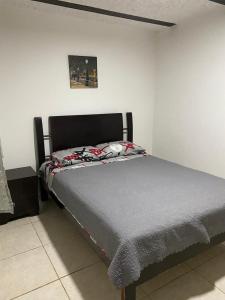 een bed in een witte kamer met een bed sidx sidx sidx bij Apartamento CERCA AEROPUERTO, Fotos y huellas para visa americana, embajada EEUU in Bogota