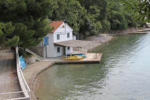 a small house on the side of a river at Apartments with a parking space Smrika, Kraljevica - 14812 in Šmrika