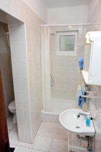 a bathroom with a sink and a shower and a toilet at Apartments by the sea Supetarska Draga - Gornja, Rab - 2016 in Supetarska Draga +67 photos