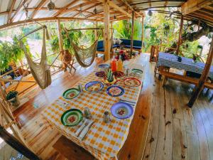 a table with plates of food on top of a wooden floor at EL GALLO ECOLODGE in San Felipe de Puerto Plata