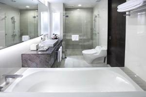 łazienka z wanną, toaletą i umywalką w obiekcie R Hotel Rancamaya w mieście Bogor