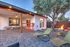 a patio with chairs and a table and a fireplace at Quiet Luxury Estate w/ Heated Pool: Scottsdale in Scottsdale