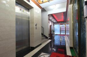 a hallway with a elevator in a building at Utopia Hotel in Gumi