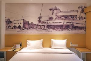 a bedroom with a drawing on the wall above a bed at PALM PARK Hotel Surabaya in Surabaya