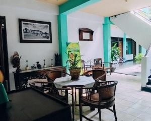 a dining room with a table and chairs at Indonesia Hotel Malioboro in Yogyakarta