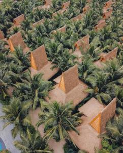 an overhead view of a jungle with palm trees and buildings at Phi Phi CoCo Beach Resort in Phi Phi Islands