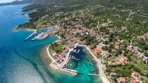 an aerial view of a small island with boats in the water at Apartments by the sea Nerezine, Losinj - 330 in Nerezine