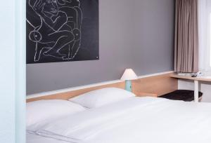 Postel nebo postele na pokoji v ubytování ibis Berlin City Nord