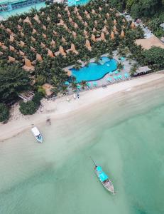 an aerial view of a beach with two boats in the water at Phi Phi CoCo Beach Resort in Phi Phi Islands