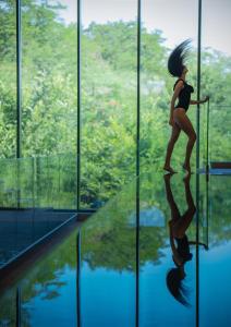 a woman standing on a pole in front of a window at HVD Reina del Mar - Premium Spa Service & Free Parking in Obzor