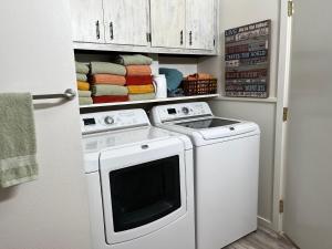 a white washer and dryer in a small bathroom at Cheerful 3 Bedroom on a Park 10 Miles from Eugene in Creswell