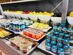 a buffet line with different types of drinks and fruit at HVD Reina del Mar - Premium Spa Service & Free Parking in Obzor