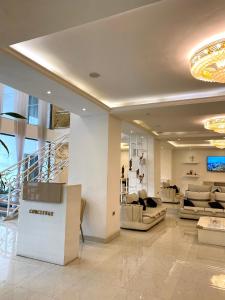 a lobby with couches and a staircase in a building at De Leopol Hotel in Addis Ababa