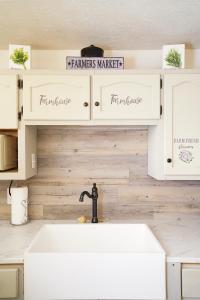 a kitchen with white cabinets and a sink at Nicura Ranch Inn & Stables in Berea