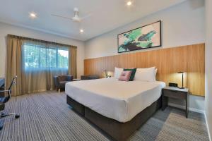 a hotel room with a large bed and a large window at Best Western Plus North Lakes Hotel in North Lakes