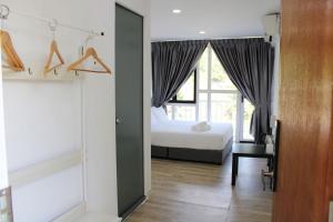 a bedroom with a bed and a desk and a window at Happy Valley Eco Farm in Kerling