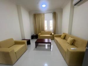 a living room with two couches and a coffee table at RED-25 - Razat Alard 4 in Salalah