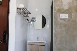a bathroom with a sink and a mirror at Happy Valley Eco Farm in Kerling