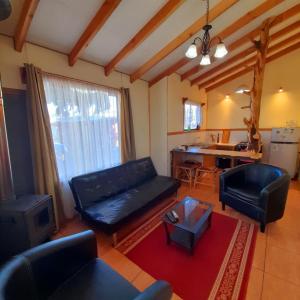 a living room with a couch and a table at Cabañas El Portal in Neltume