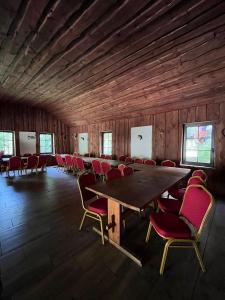 a conference room with a large wooden table and chairs at Chata Baryła in Sulęczyno +33 photos