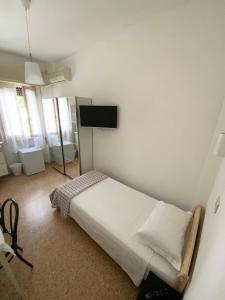 sypialnia z łóżkiem i telewizorem z płaskim ekranem w obiekcie Hotel Naviglio w mieście Marina di Pietrasanta