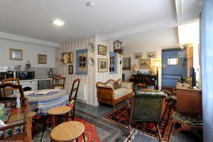 a living room with a table and chairs at Le Studio d'Eugénie 