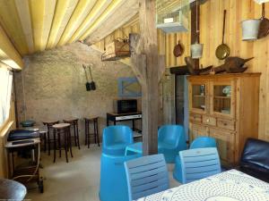 ein Esszimmer mit blauen Stühlen und einem Tisch in der Unterkunft Le Studio d'Eugénie 