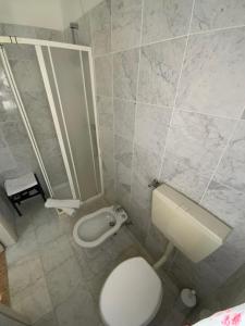 a bathroom with a white toilet and a sink at Hotel Naviglio in Marina di Pietrasanta