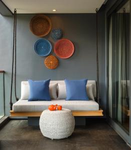 a living room filled with furniture and a blue couch at Hotel Indigo Bali Seminyak Beach, an IHG Hotel in Seminyak