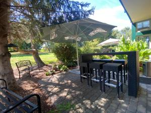 a table and chairs under an umbrella on a patio at Vanilla Hof in Wethau