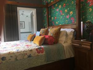 a bedroom with a bed with a floral bedspread at The Music House in Grantham