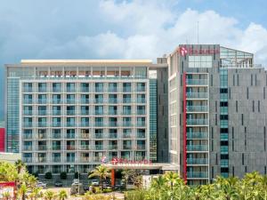 a tall building with a virgin america sign on it at Ramada by Wyndham Jeju Hamdeok in Jeju