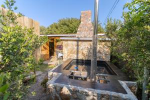 a stone house with a fireplace in a yard at Happy Van in Scarborough