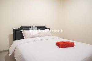 Un pat sau paturi într-o cameră la Astana Malioboro Mitra RedDoorz