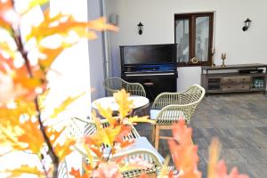 a living room with chairs and a table and a tv at Apartments in the heart of Sibiu in Sibiu