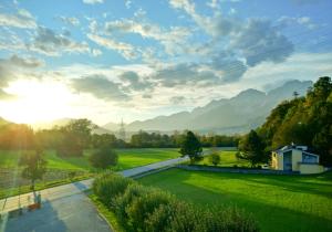 a view of a park with mountains in the background at Bed & Breakfast Plattenhof in Telfs