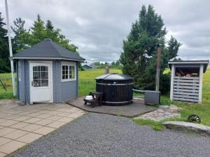 a gazebo and a wooden deck with a hot tub at Villa Orismala in Isokyrö